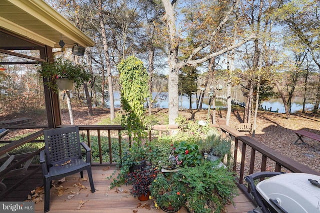 wooden deck featuring a water view