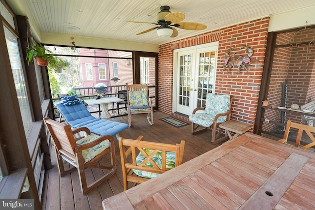 sunroom featuring french doors, ceiling fan, and wooden ceiling