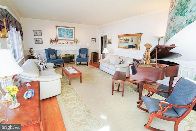 living room with a fireplace, wood-type flooring, and crown molding