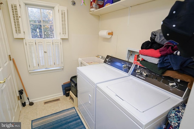 laundry room featuring tile patterned flooring and washer and clothes dryer