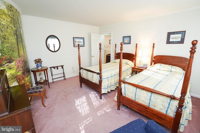 bedroom with ornamental molding and carpet floors