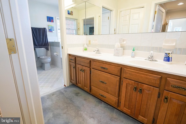 bathroom with tile walls, tile patterned flooring, vanity, and toilet