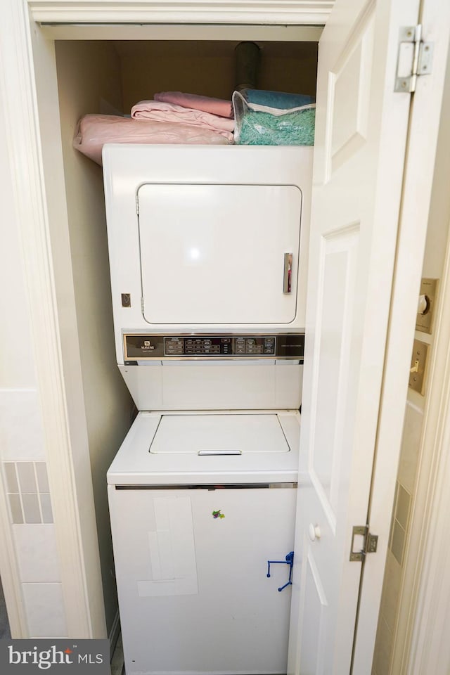 laundry area featuring stacked washer and dryer