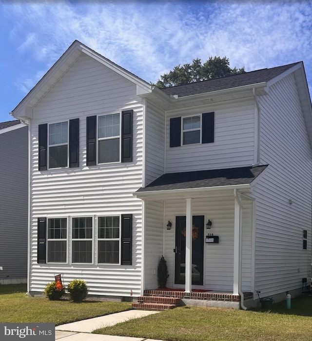 view of front of house featuring covered porch and a front yard