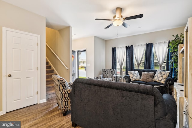 living room with ceiling fan and light wood-type flooring