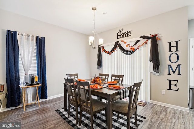 dining room with an inviting chandelier and wood-type flooring