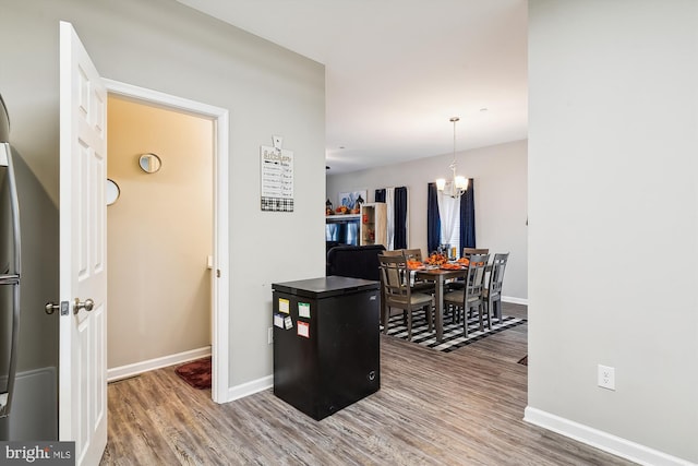 kitchen with an inviting chandelier and hardwood / wood-style flooring