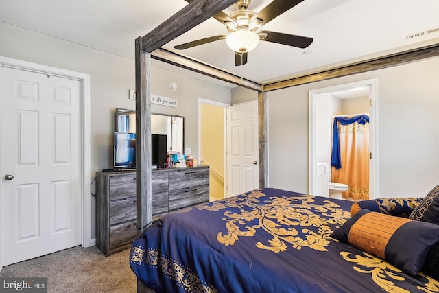 carpeted bedroom with ensuite bath and ceiling fan