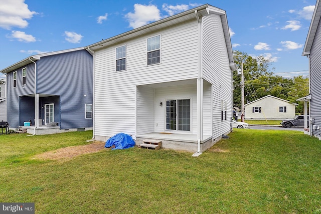 rear view of property featuring a yard