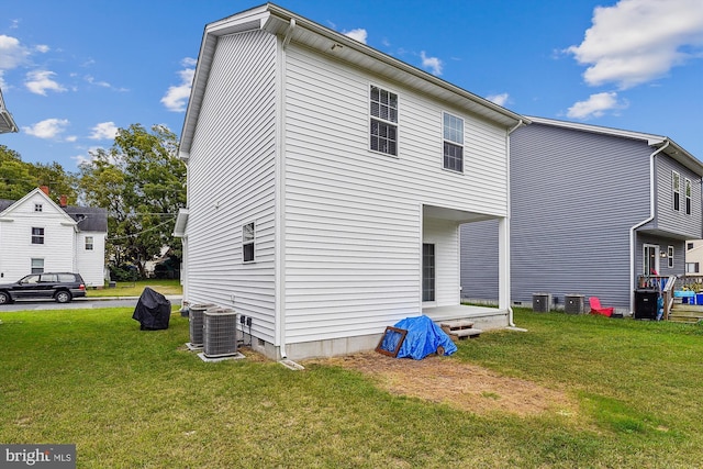 rear view of property with a lawn