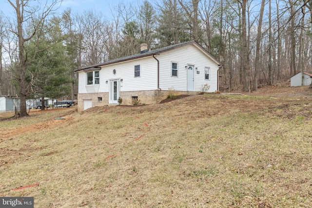 split foyer home featuring a front lawn and a garage