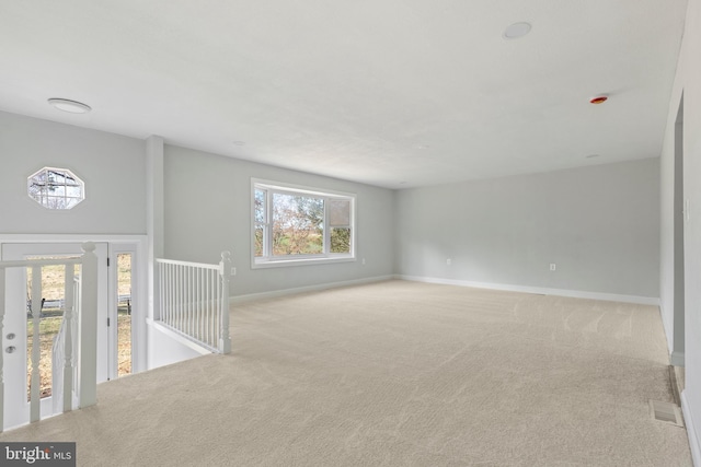 carpeted empty room with baseboards