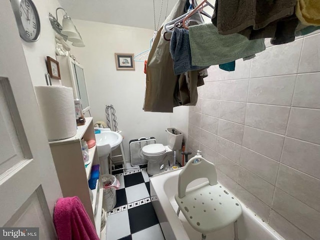 bathroom featuring a tub to relax in and toilet