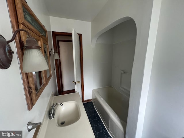 bathroom with a bathing tub and sink