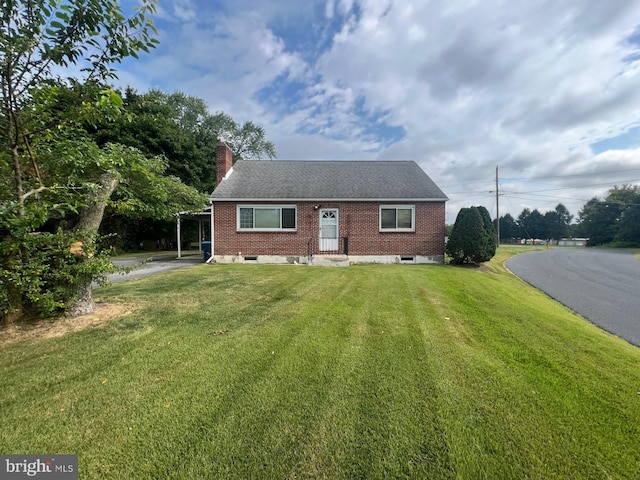 view of front facade with a front lawn and a carport