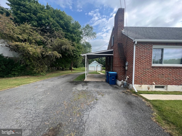 view of home's exterior with a carport and a yard