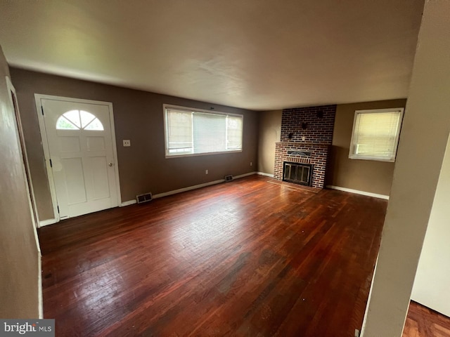 entryway with a fireplace and dark hardwood / wood-style flooring