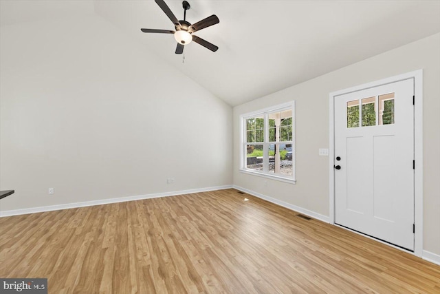 foyer entrance with a wealth of natural light, ceiling fan, high vaulted ceiling, and light wood-type flooring