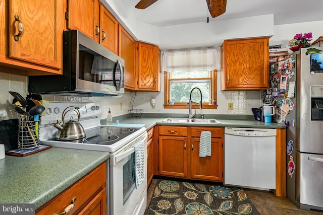 kitchen with appliances with stainless steel finishes, sink, ceiling fan, and tasteful backsplash