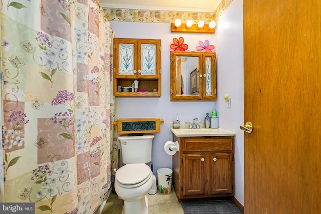 bathroom with walk in shower, crown molding, vanity, and toilet