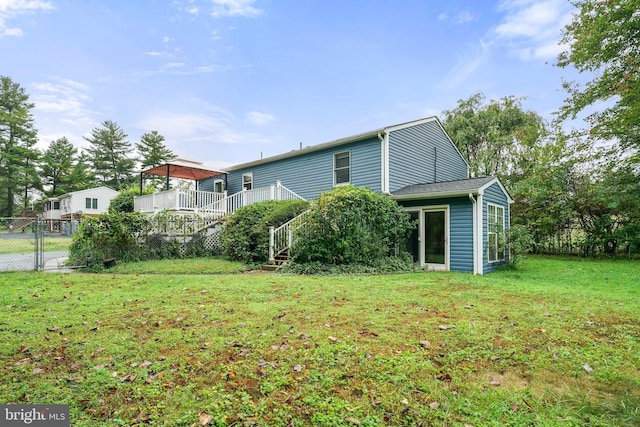 exterior space featuring a deck and a lawn