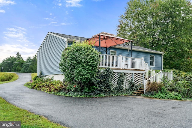 view of home's exterior featuring a wooden deck