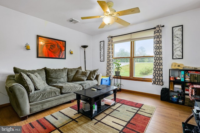 living room with ceiling fan and hardwood / wood-style floors