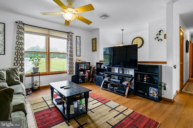 living room with ceiling fan and hardwood / wood-style floors