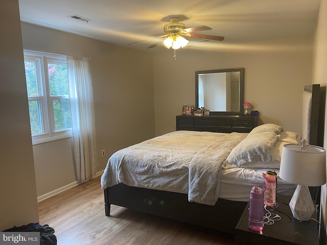 bedroom with ceiling fan and wood-type flooring