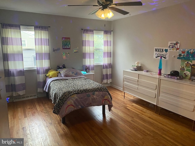 bedroom with wood-type flooring and ceiling fan