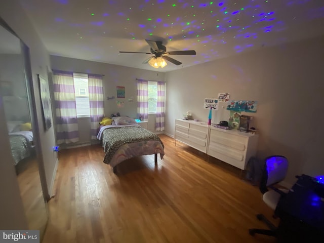 bedroom with ceiling fan and hardwood / wood-style flooring