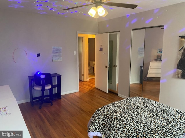 bedroom featuring ceiling fan, a closet, and dark wood-type flooring