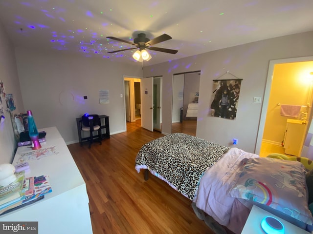 bedroom featuring ceiling fan, hardwood / wood-style flooring, and ensuite bathroom