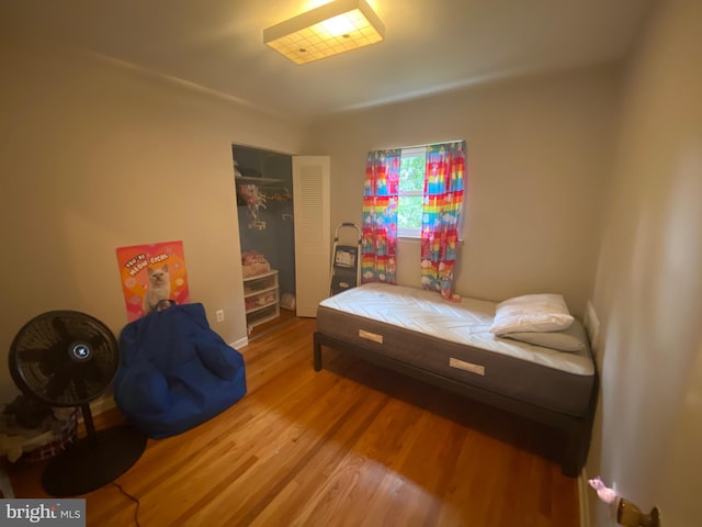 bedroom with hardwood / wood-style flooring