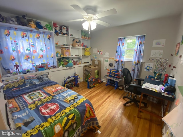 bedroom with ceiling fan and light hardwood / wood-style flooring