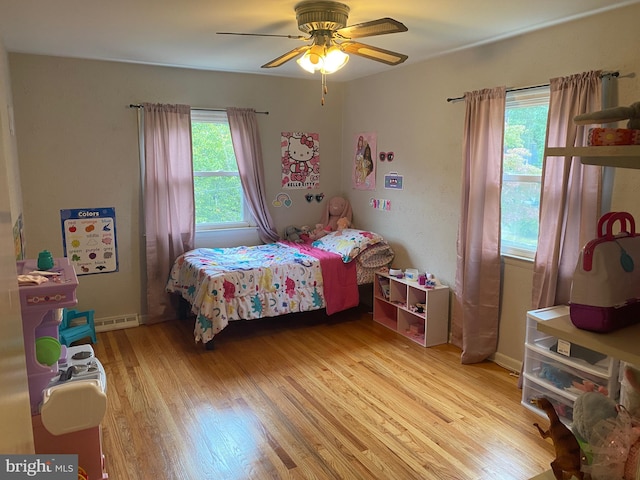 bedroom with light hardwood / wood-style flooring and ceiling fan