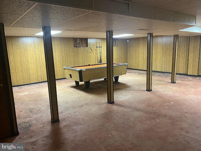 basement with wooden walls, billiards, and a paneled ceiling