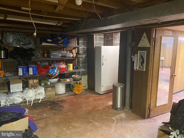 basement featuring white fridge