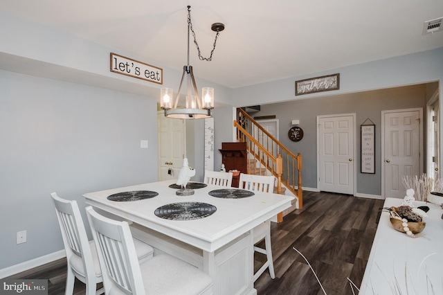 kitchen with a chandelier, hanging light fixtures, and dark hardwood / wood-style flooring