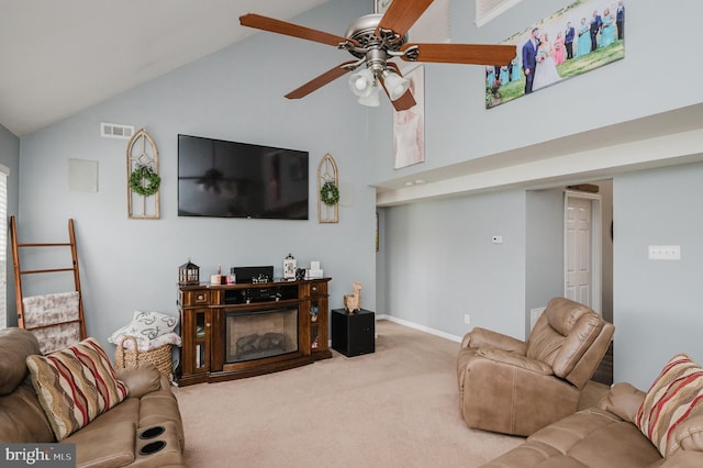 carpeted living room featuring ceiling fan and high vaulted ceiling