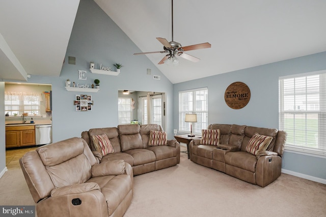 carpeted living room with high vaulted ceiling, sink, and ceiling fan