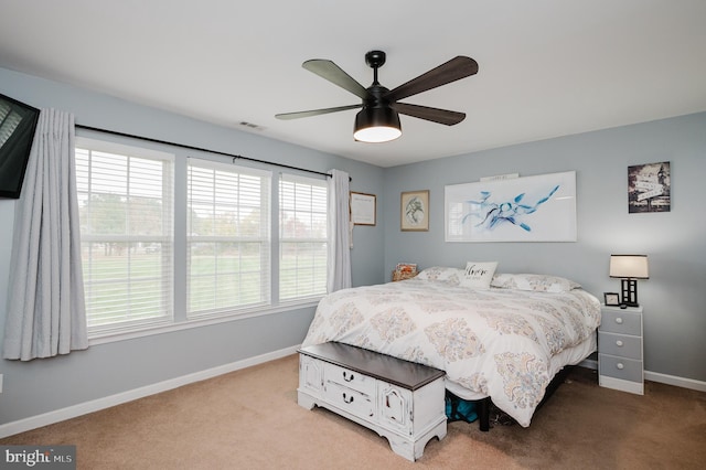 bedroom with ceiling fan and light carpet