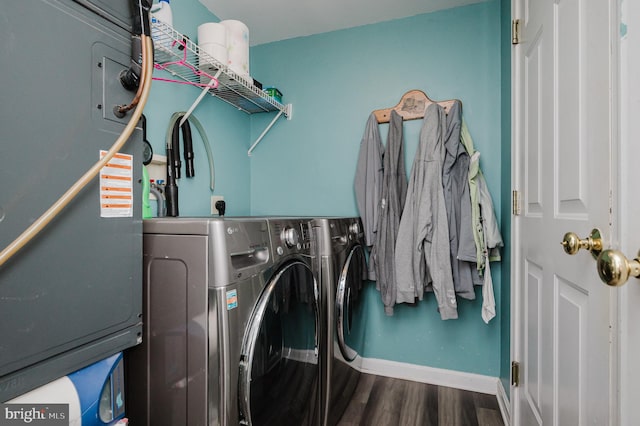 laundry area with washer and dryer and dark wood-type flooring