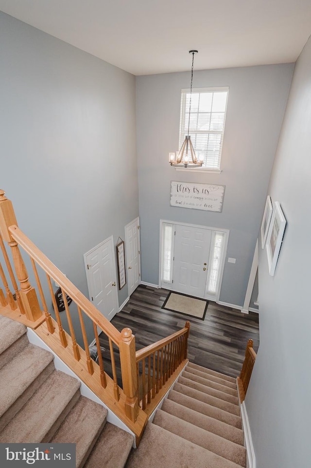 foyer featuring a chandelier and dark hardwood / wood-style flooring