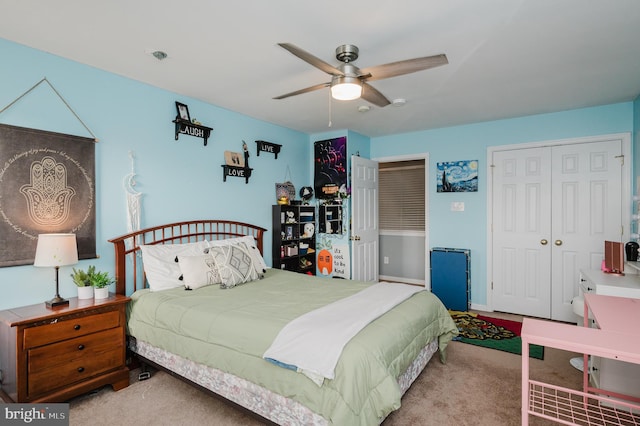 carpeted bedroom featuring a closet and ceiling fan