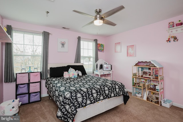 bedroom with ceiling fan, multiple windows, and carpet floors