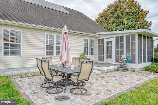 view of patio featuring a sunroom