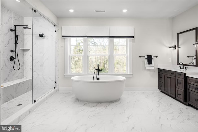 bathroom with vanity and separate shower and tub