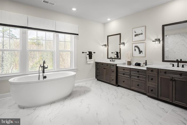 bathroom featuring vanity and a tub