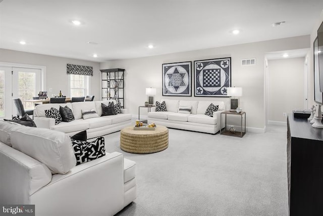 carpeted living room featuring french doors